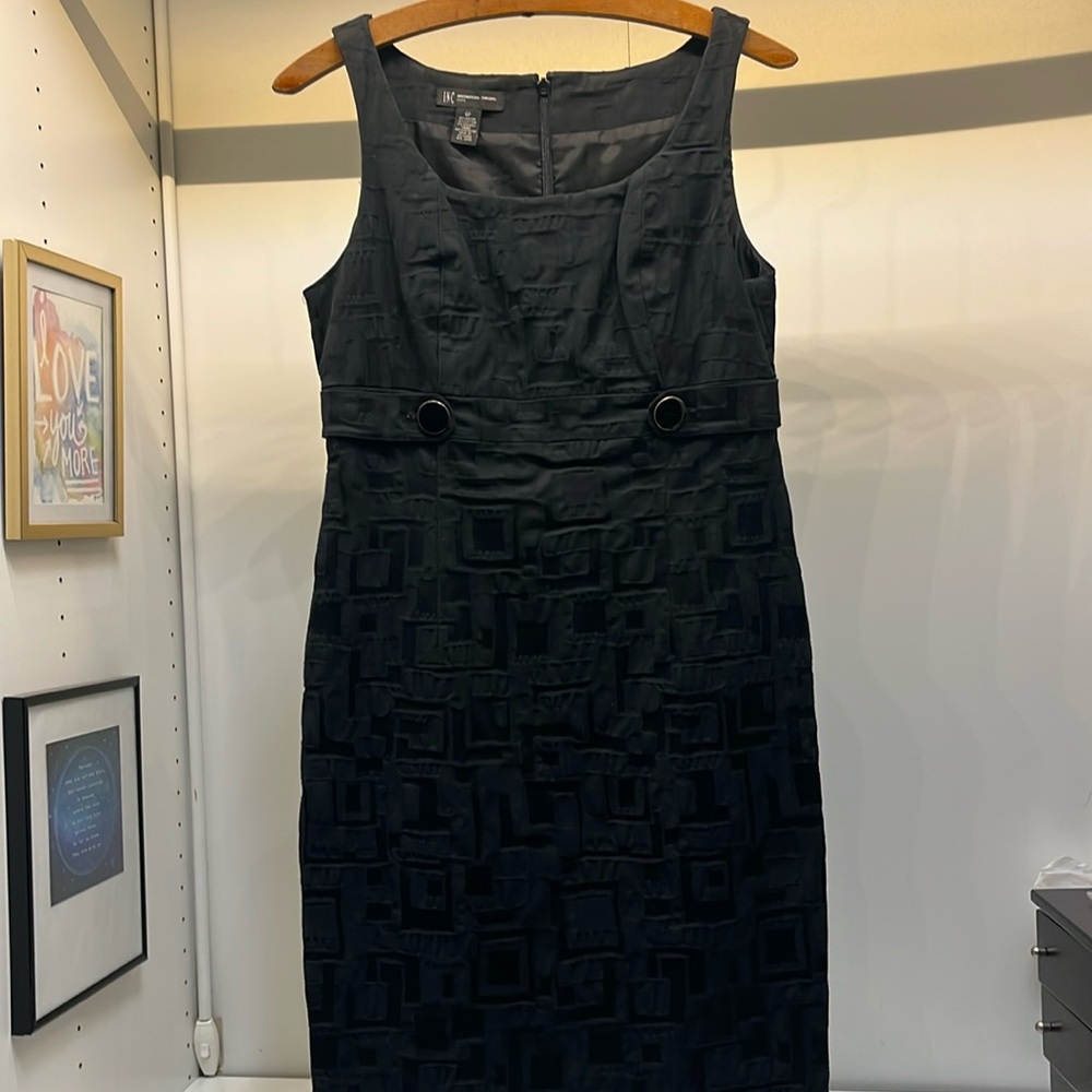 Six petite little black dress with button accents.